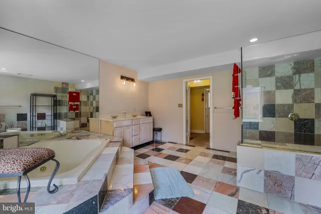a large bathroom with a double vanity sink a mirror and a bathtub