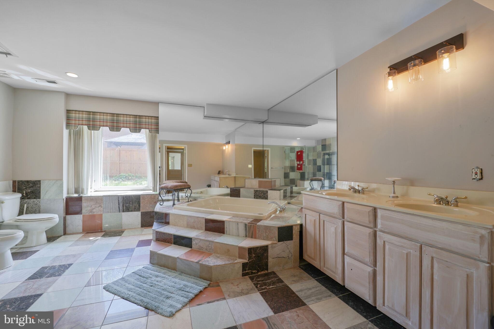 1410 Missouri Avenue Northwest Washington, DC 20011 - Photo 17 of 38 a large bathroom with a double vanity sink a mirror and a bathtub