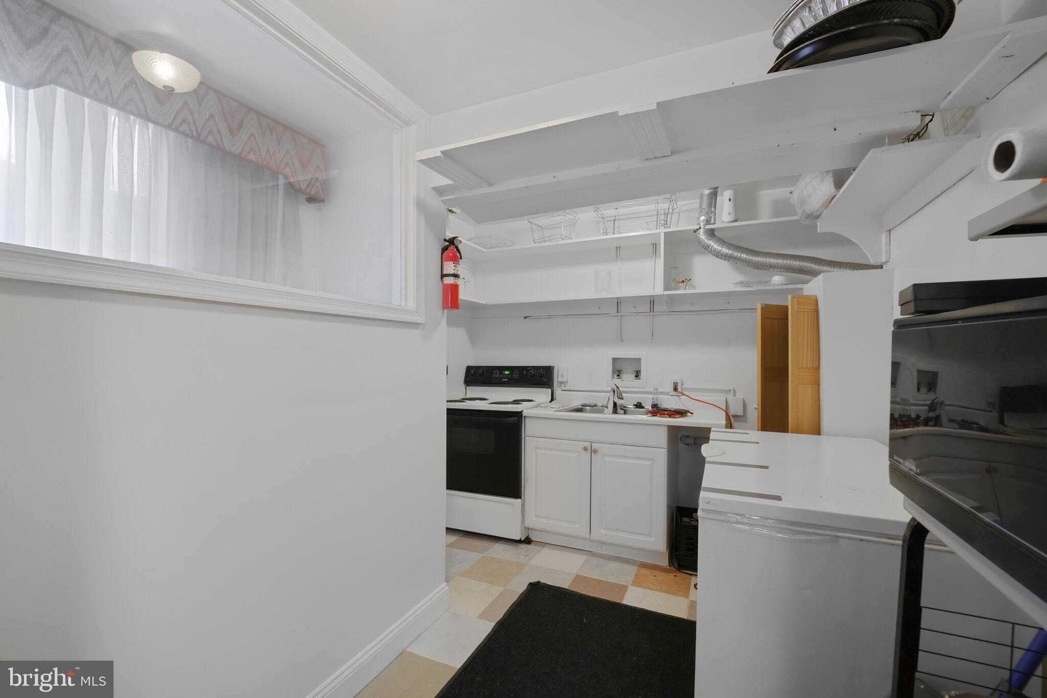 1410 Missouri Avenue Northwest Washington, DC 20011 - Photo 25 of 38 a kitchen with a sink cabinets and stainless steel appliances