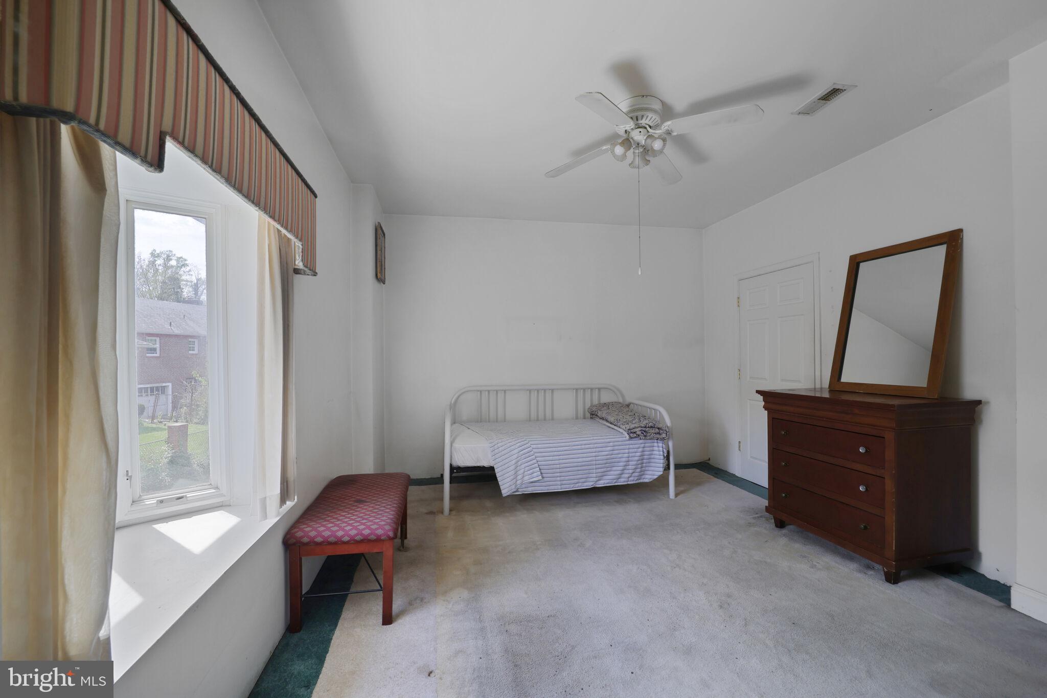 1410 Missouri Avenue Northwest Washington, DC 20011 - Photo 29 of 38 a bedroom with a bed and a chandelier