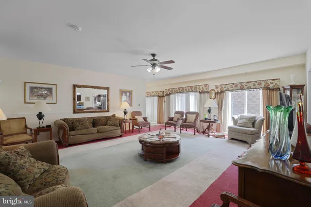 a bedroom with a bed and dresser with wooden floor