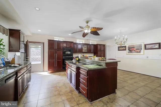 a kitchen with stainless steel appliances wooden cabinets and center island