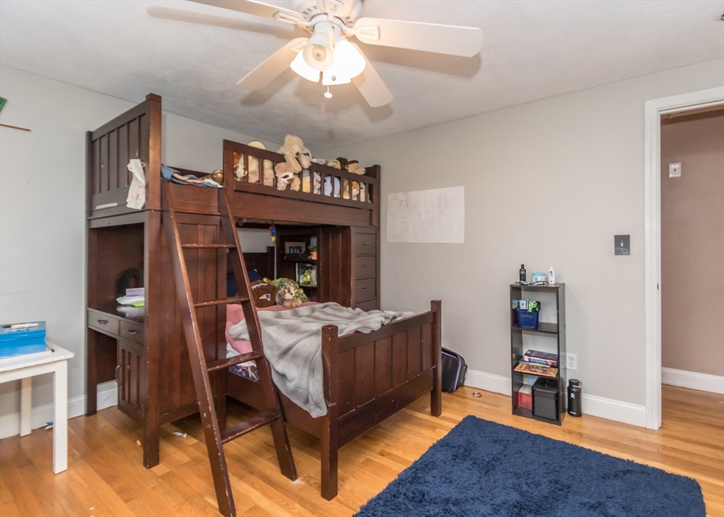 27 Sherman Street Needham, MA 02494 - Photo 20 of 32 a bedroom with a bed and a chandelier