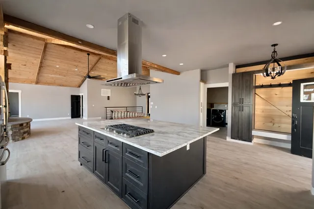 a kitchen that has a stove and a table in it