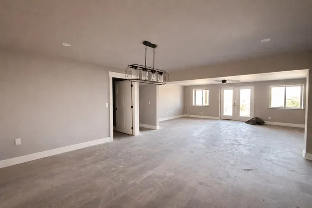 a living room with a couch and a chandelier