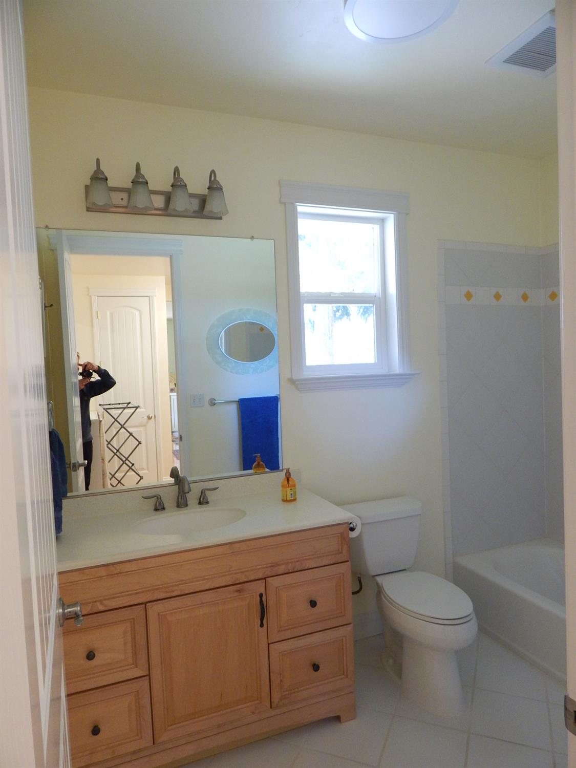1717 Union Ridge Road Placerville, CA 95667 - Photo 23 of 55 a bathroom with a granite countertop toilet a sink a mirror and bathtub