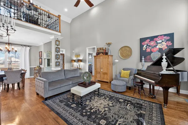 a living room with furniture and wooden floor