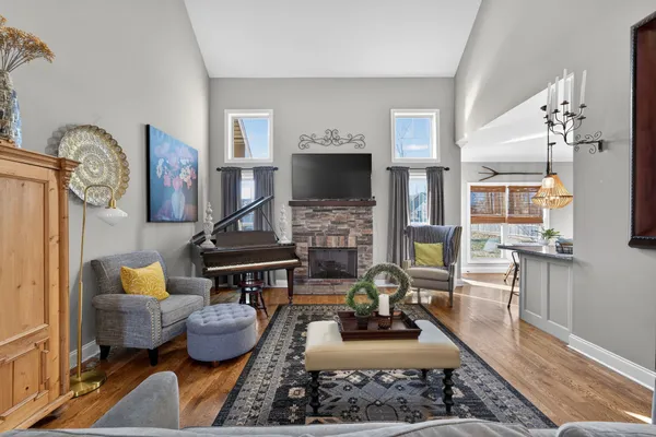 a living room with furniture and wooden floor