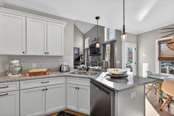a kitchen with sink and cabinets