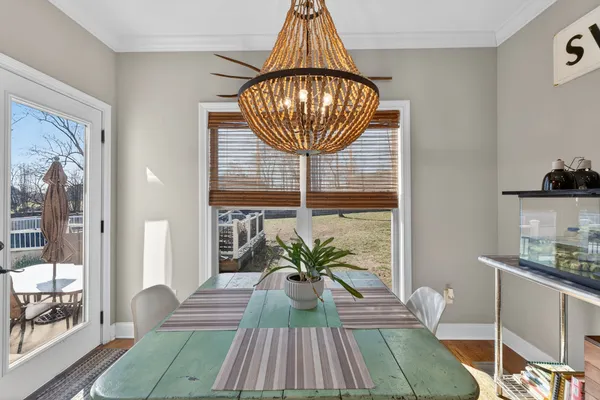 a view of dining room with furniture wooden floor and a chandelier