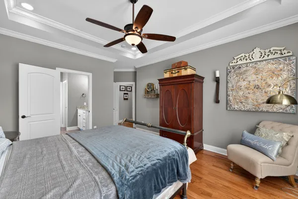 a bedroom with a bed and a chandelier