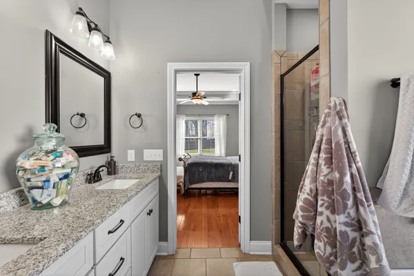 a bathroom with a granite countertop sink and a mirror