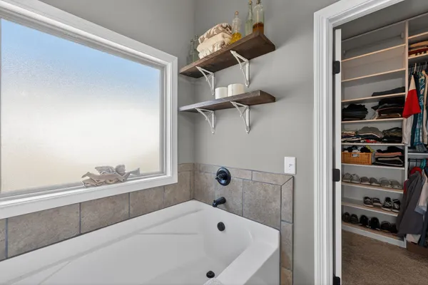 a bathroom with a bathtub and a window