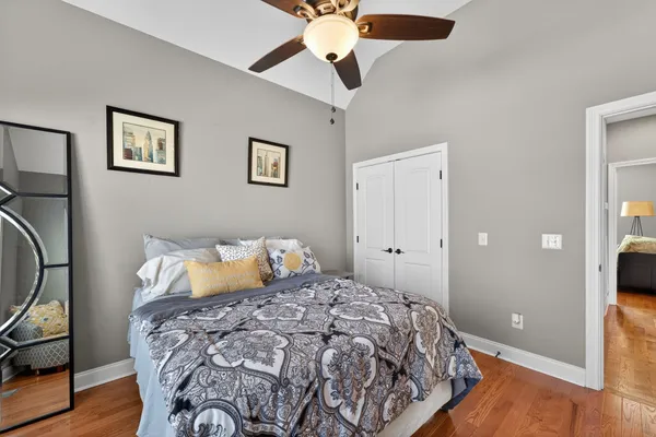 a bedroom with a bed and a chandelier