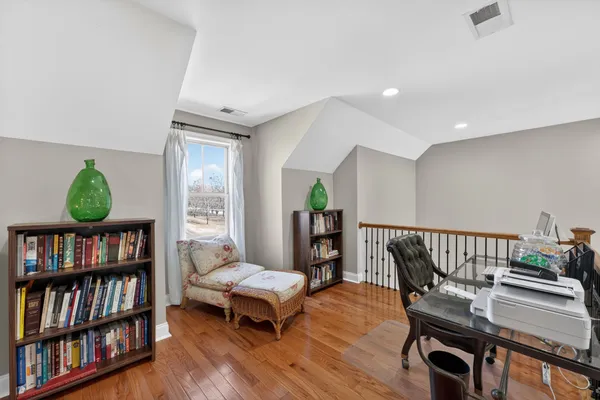 a living room with furniture and a book shelf