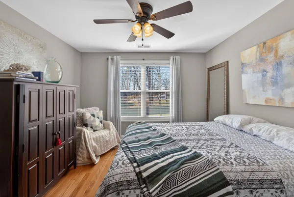 a bedroom with a bed and a window