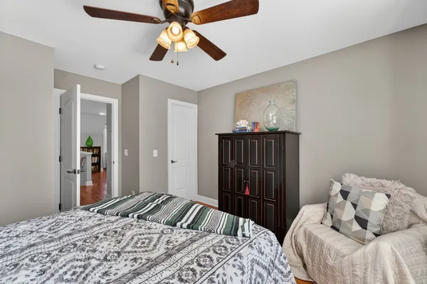 a bedroom with a bed and a chandelier