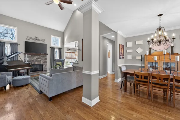 a living room with furniture and a chandelier