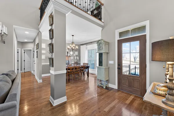 a living room with furniture a dining table and wooden floor