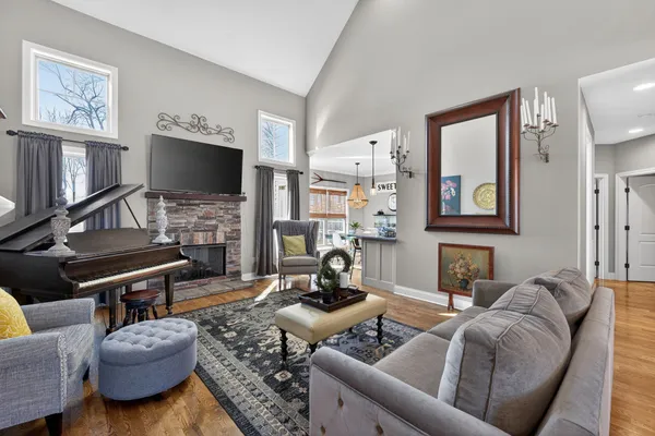a living room with furniture a flat screen tv and a window