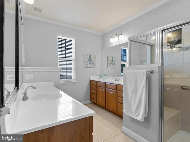 a spacious bathroom with a shower sink and mirror