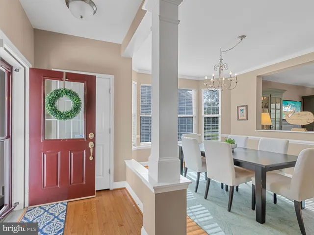 a view of a dining room with furniture and chandelier