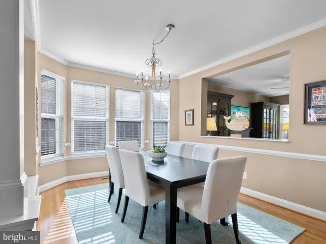 a view of a dining room with furniture wooden floor and chandelier