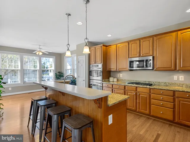 a large kitchen with kitchen island a large window