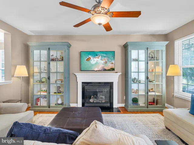 a living room with furniture fireplace and a large window