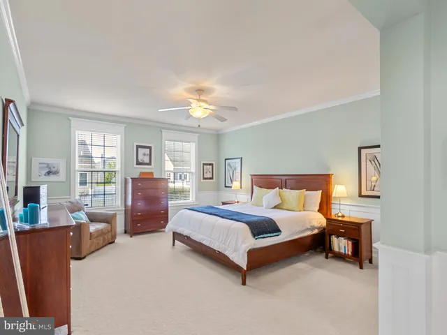 a spacious bedroom with a bed and wooden cabinets