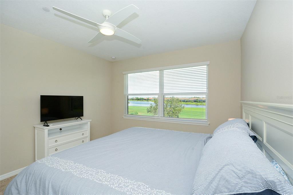 13737 Messina Loop, Unit 202 Lakewood Ranch, FL 34211 - Photo 25 of 49 a bedroom with a bed tv and a window