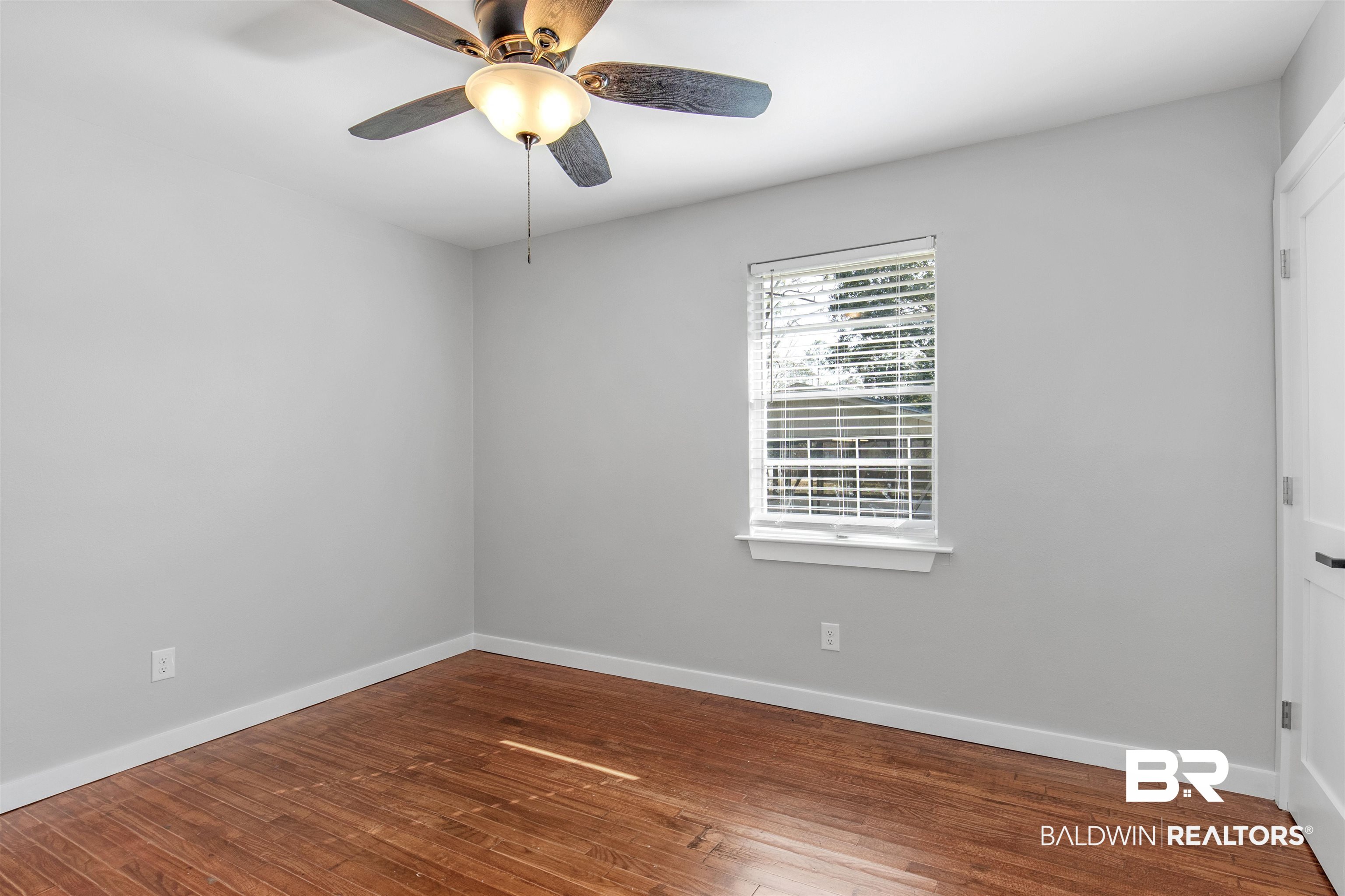 3005 Club House Road Mobile, AL 36605 - Photo 11 of 20 Spare room with hardwood / wood-style flooring and ceiling fan