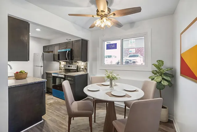 a kitchen with a table and chairs in it