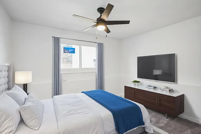 a bedroom with a bed and a flat screen tv