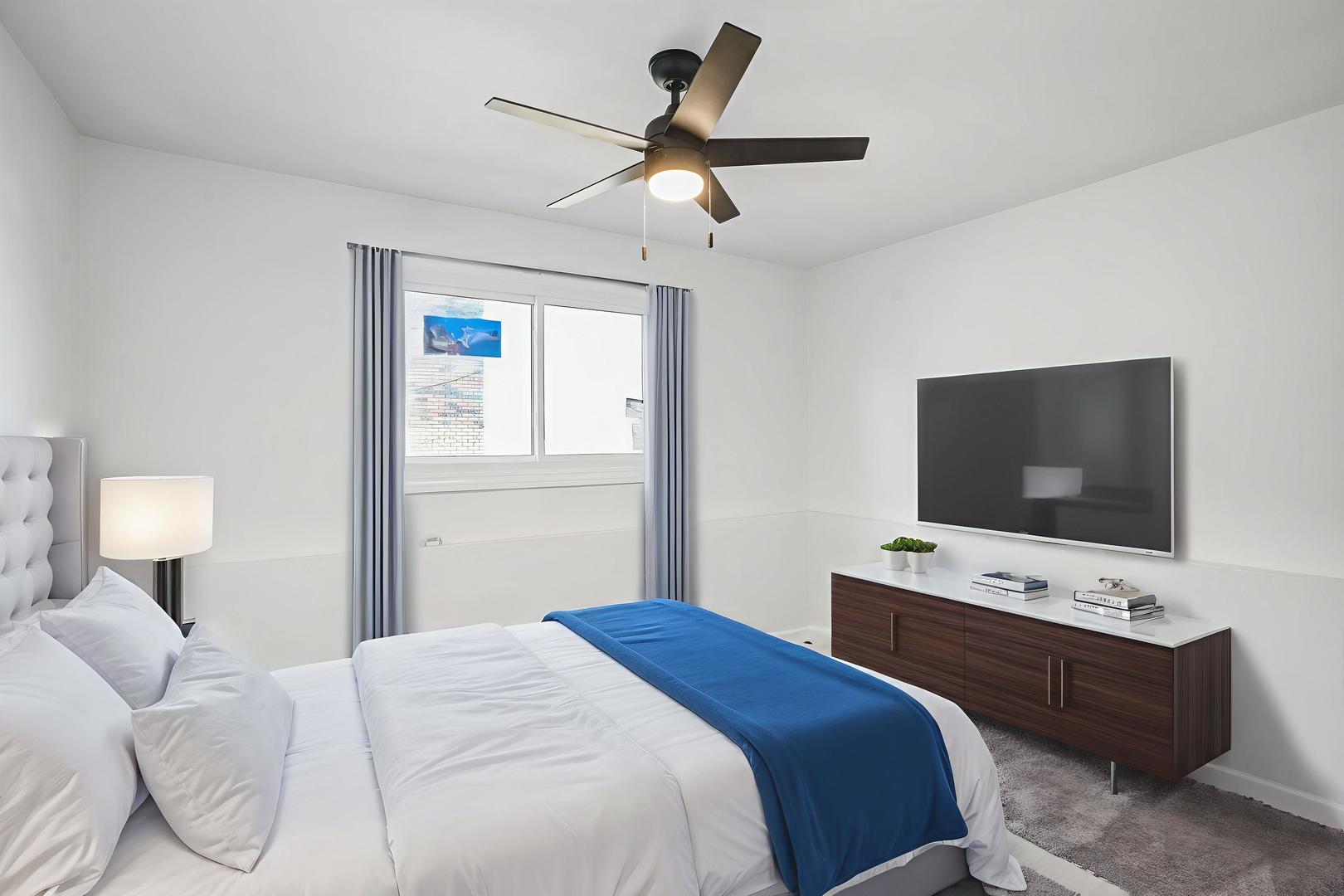 535 Pasadena Avenue, Unit 3 Crest Hill, IL 60403 - Photo 6 of 10 a bedroom with a bed and a flat screen tv