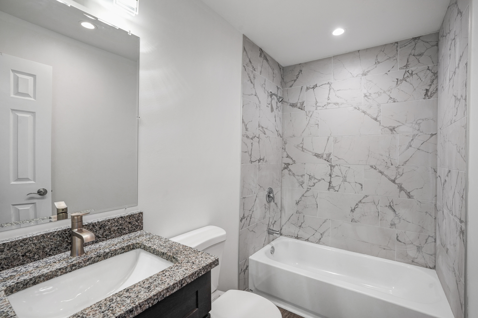 535 Pasadena Avenue, Unit 3 Crest Hill, IL 60403 - Photo 8 of 10 a bathroom with a granite countertop sink a toilet and bathtub