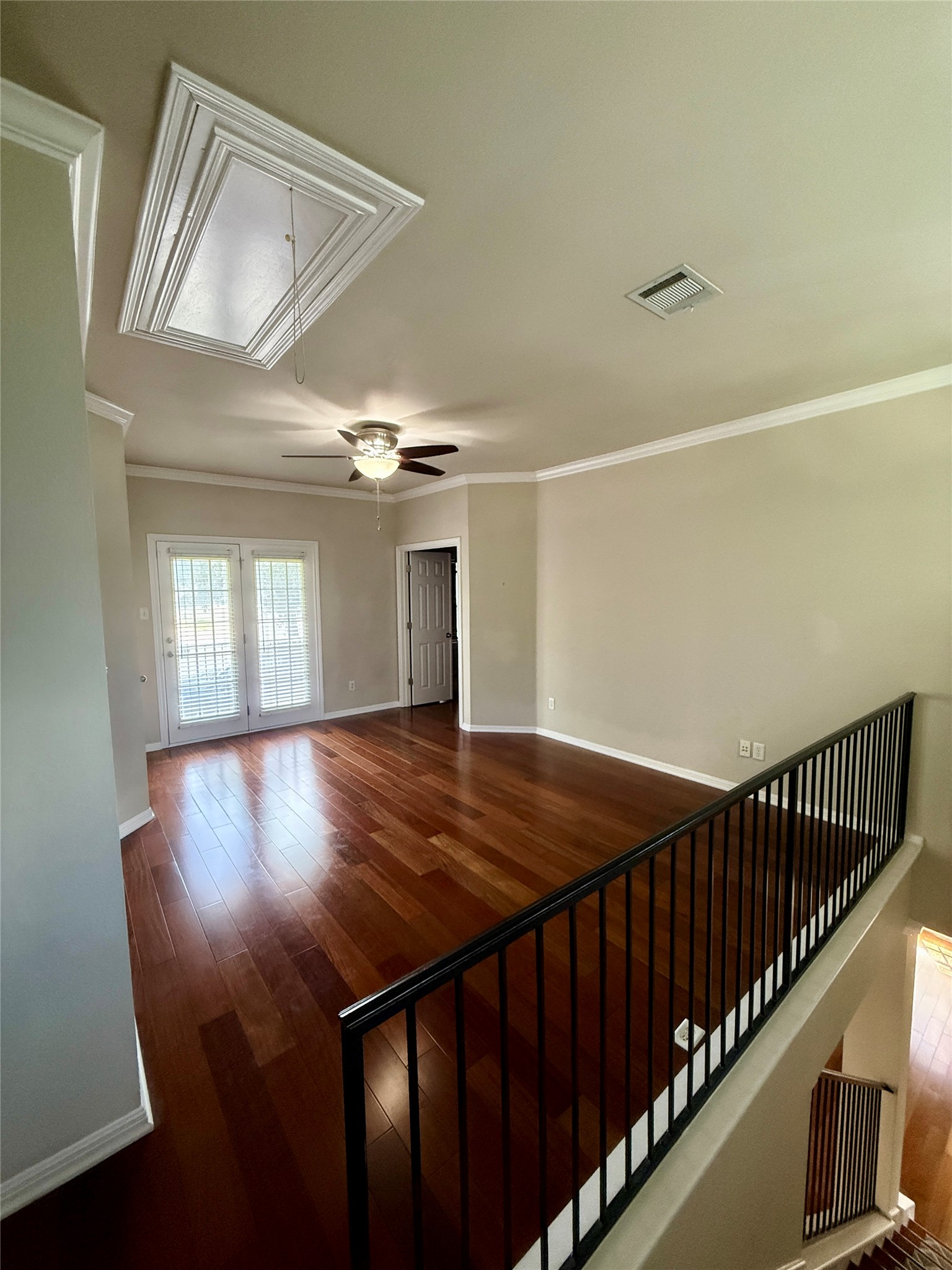411 West St Elmo Road, Unit 39 Austin, TX 78745 - Photo 10 of 25 Gleaming hardwood floors and classic crown molding define this versatile upper-level living space. French doors lead to covered patio