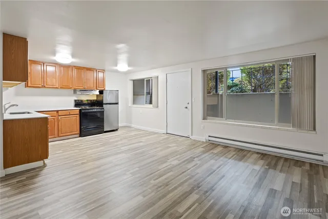 a view of kitchen with sink and wooden floor