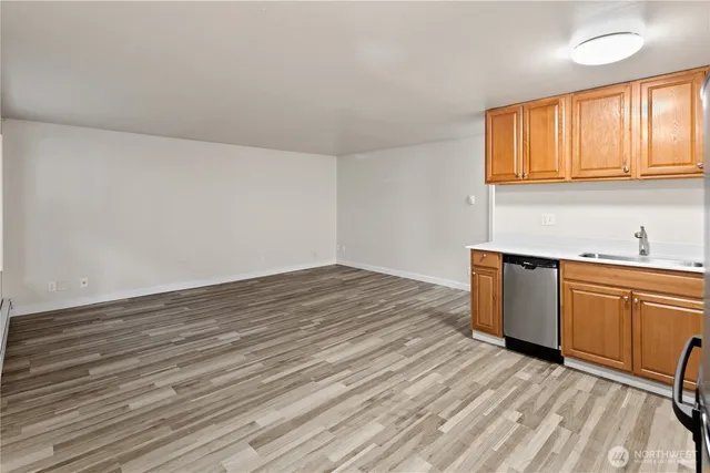 a view of a kitchen with wooden floor and a sink