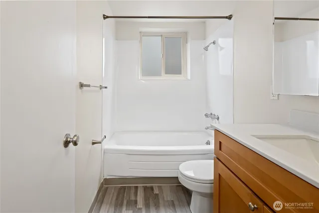 a kitchen with wooden floors and wooden cabinets