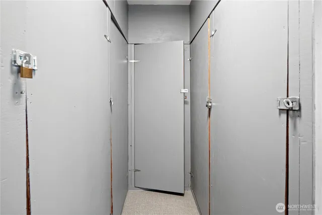 a view of a white building among the street with palm trees