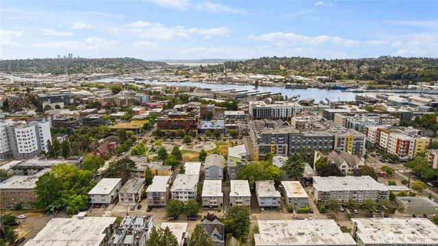 an aerial view of residential houses with city view
