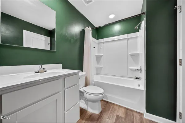 a bathroom with a sink a toilet and a large mirror