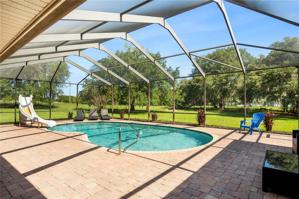 9045 Lake Hatchineha Road Kissimmee, FL 34759 - Photo 41 of 47 a view of a swimming pool with a patio