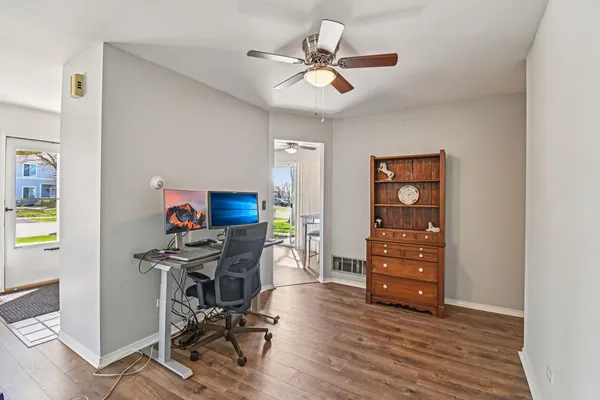 a view of workspace with wooden floor and ceiling fan
