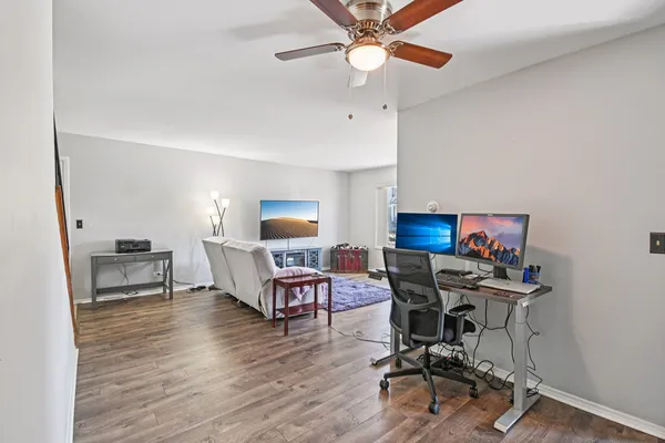 a view of a workspace with furniture and a window