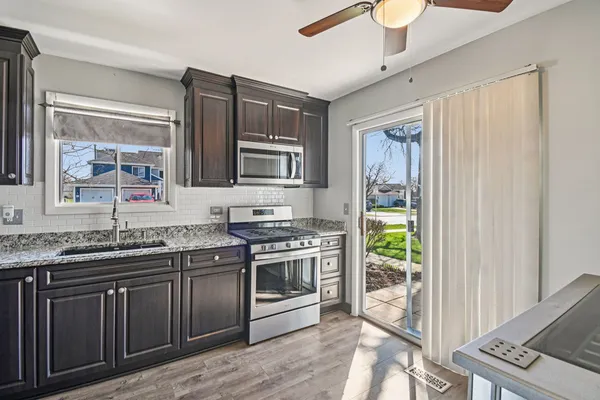 a kitchen with stainless steel appliances granite countertop a stove and a sink