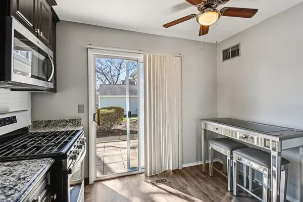 a kitchen with stainless steel appliances granite countertop a stove and a refrigerator