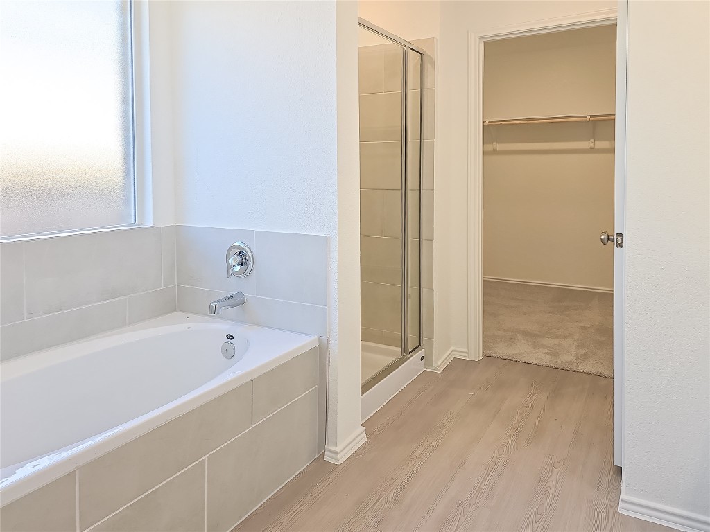 1117 Nesting Bird Drive Georgetown, TX 78628 - Photo 15 of 20 a bathroom with a bathtub and a shower