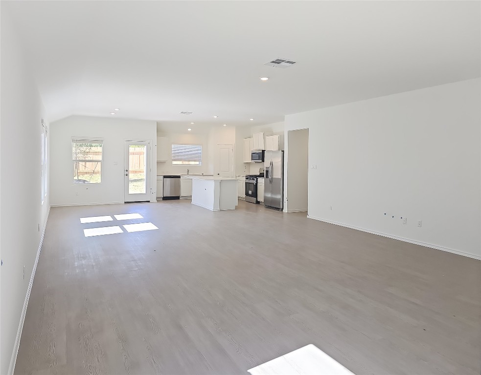 1117 Nesting Bird Drive Georgetown, TX 78628 - Photo 3 of 20 a view of empty room with windows and kitchen view